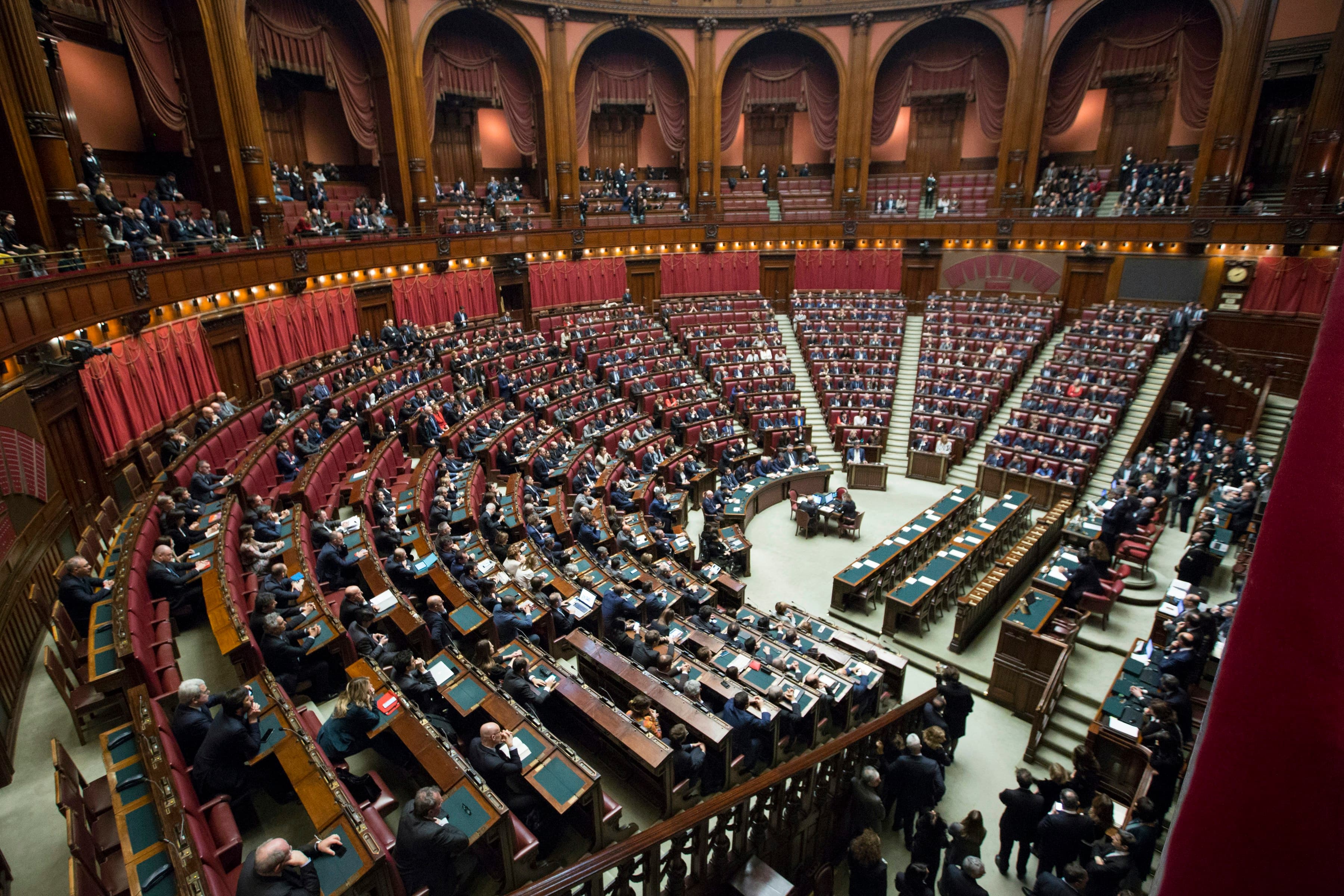 Members seated in a large legislative assembly chamber