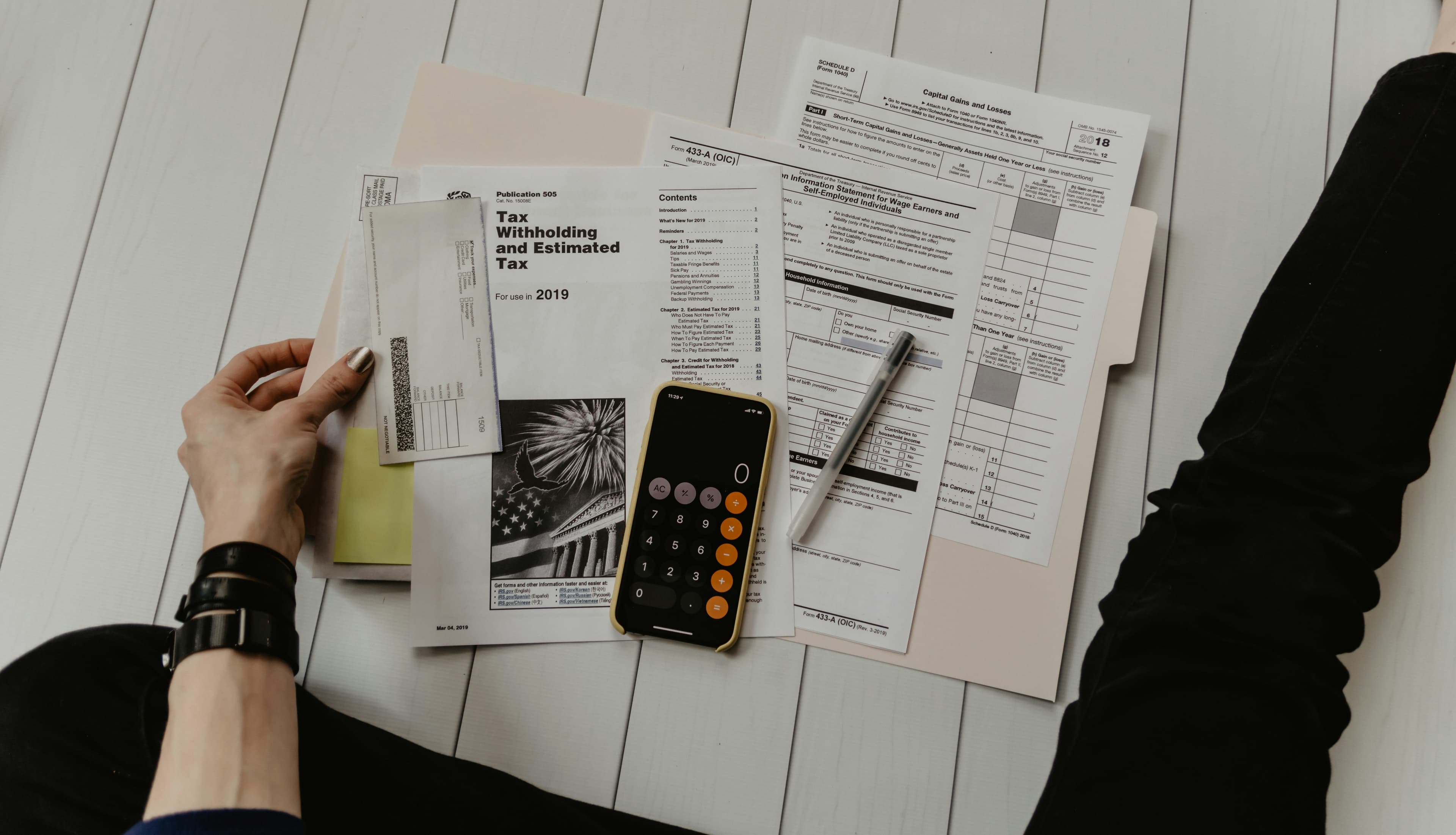 Person working through bills with a calculator